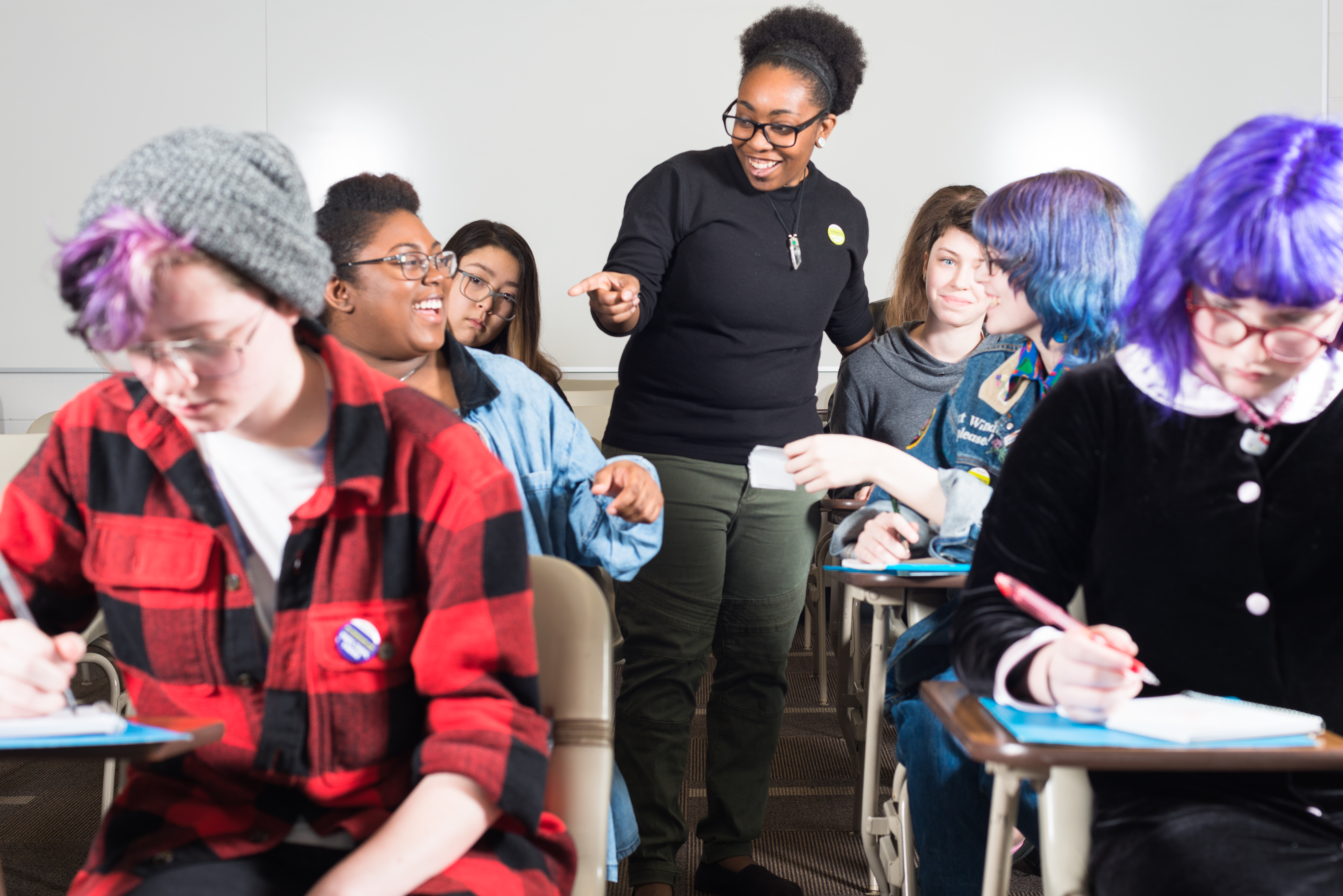 Teacher walking through classroom answering questions